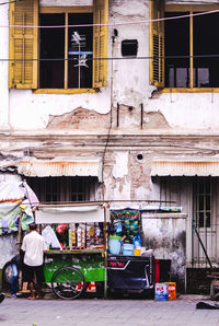 People on street against buildings in city