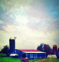 Buildings against cloudy sky