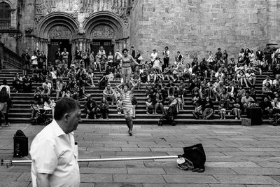 Rear view of people sitting on steps