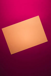 High angle view of paper against colored background