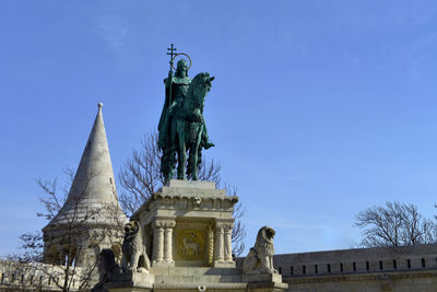 Low angle view of statue against blue sky