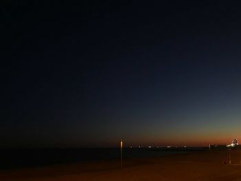 Scenic view of sea against clear sky at night