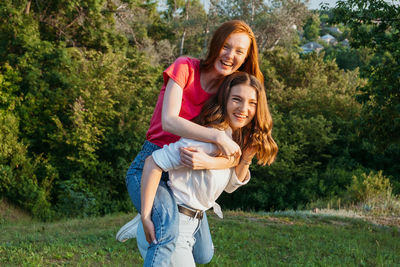 Two happy cheerful young loving girl friends having fun on nature background. two friends gen z 