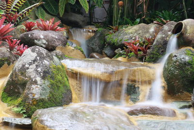 Close-up of waterfall amidst rocks in water