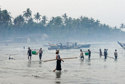 People on beach against sky