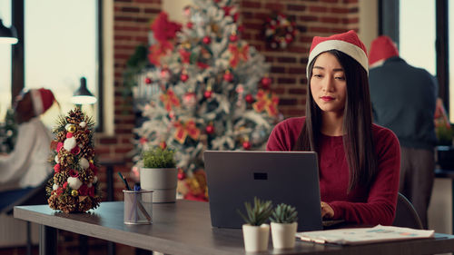 Young woman using laptop at table