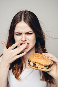 Portrait of young woman holding ice cream