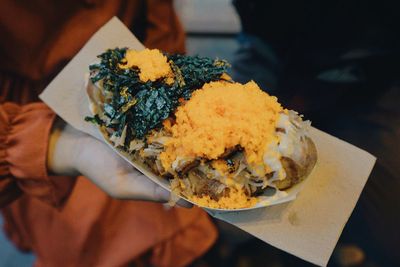 Close-up of person holding food in plate