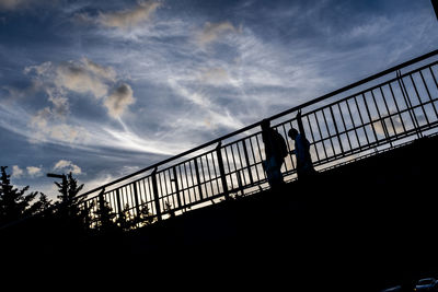 Low angle view of silhouette bridge against sky