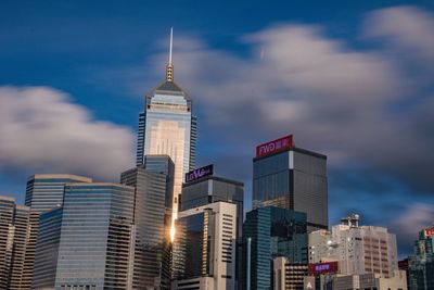 Low angle view of buildings against cloudy sky