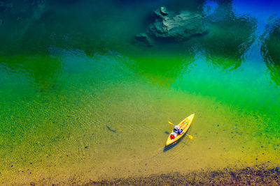 High angle view of person sitting in boat on sea