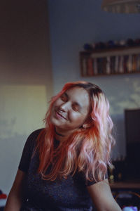 Portrait of smiling young woman at home