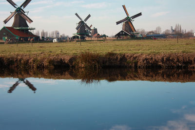 Traditional windmill on field against sky