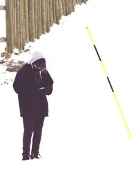 Rear view of man standing in snow
