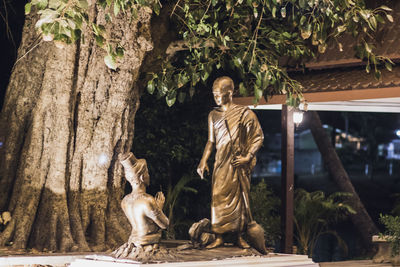 Statue against trees and plants
