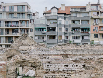 View of residentional buildings on the background of old ruins