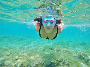 Portrait of woman swimming undersea