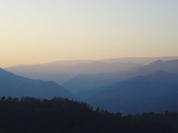 Scenic view of silhouette mountains against sky during sunset