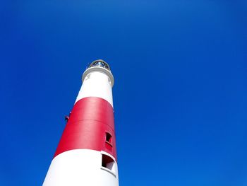 Low angle view of lighthouse against clear blue sky