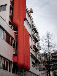 Low angle view of red building against sky