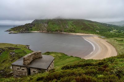 Scenic view of sea and mountains against sky