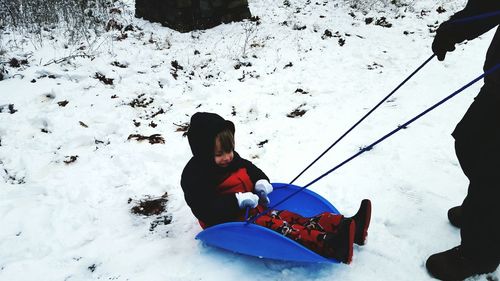 High angle view of boy playing in snow