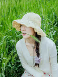 Portrait of young woman standing amidst plants