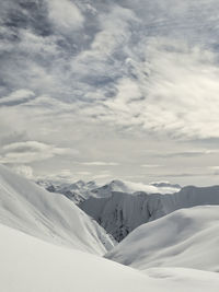 Scenic view of snow covered mountains against sky