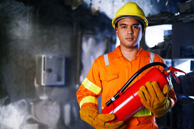 Portrait of man standing in factory