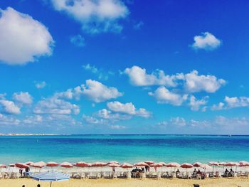 Scenic view of beach against blue sky