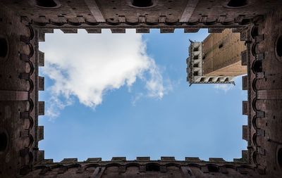 Low angle view of building against cloudy sky