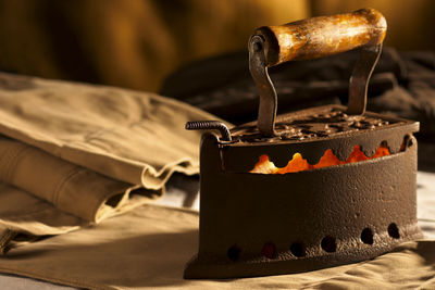 Close-up of burning candles on metal