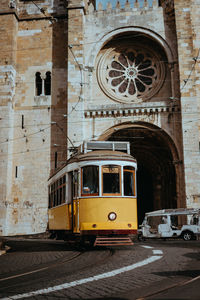 View of cable car on railroad tracks by building