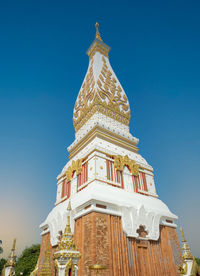 The pagoda of wat phra that panom temple in nakhon phanom in cloudy blue sky day with sunlight