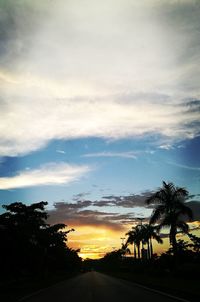 Silhouette of trees against cloudy sky