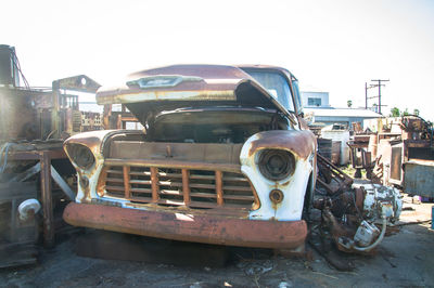 Abandoned car against clear sky