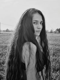 Portrait of woman standing on field