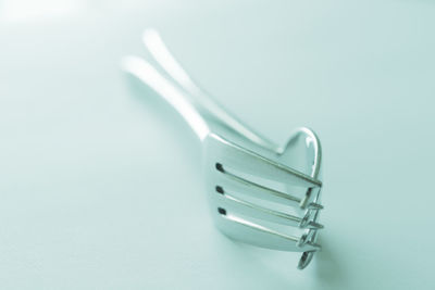 Close-up of metallic object over white background