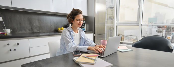 Portrait of young businesswoman working in office