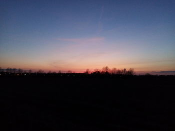 Scenic view of silhouette landscape against clear sky during sunset