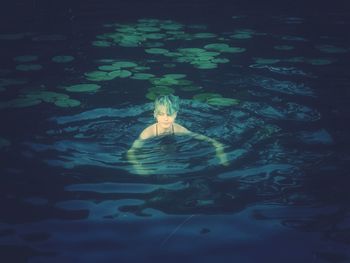 High angle view of woman swimming in pool