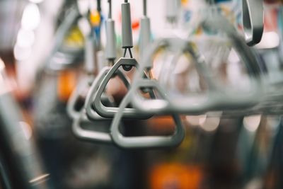 Close-up of bicycle hanging on metal grate