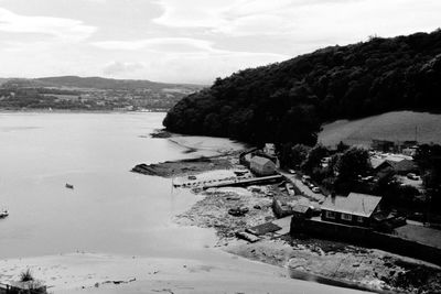 High angle view of townscape by sea against sky