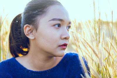 Close-up portrait of young woman looking away