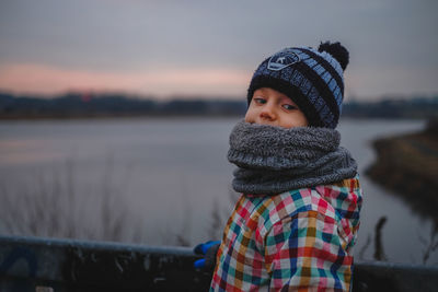 Portrait of smiling young woman in lake during winter