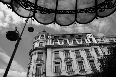 Low angle view of building against cloudy sky