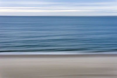 Blurred motion of sea against sky