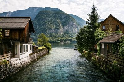 Houses in river against mountains