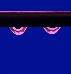 Close-up of hand against blue background