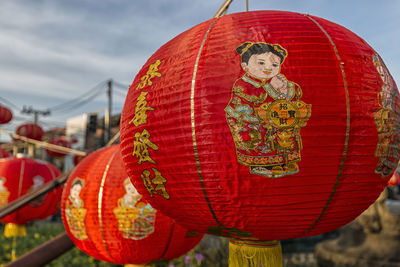 Close-up of red lanterns hanging against sky